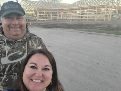 Man and Woman standing in front of new building project